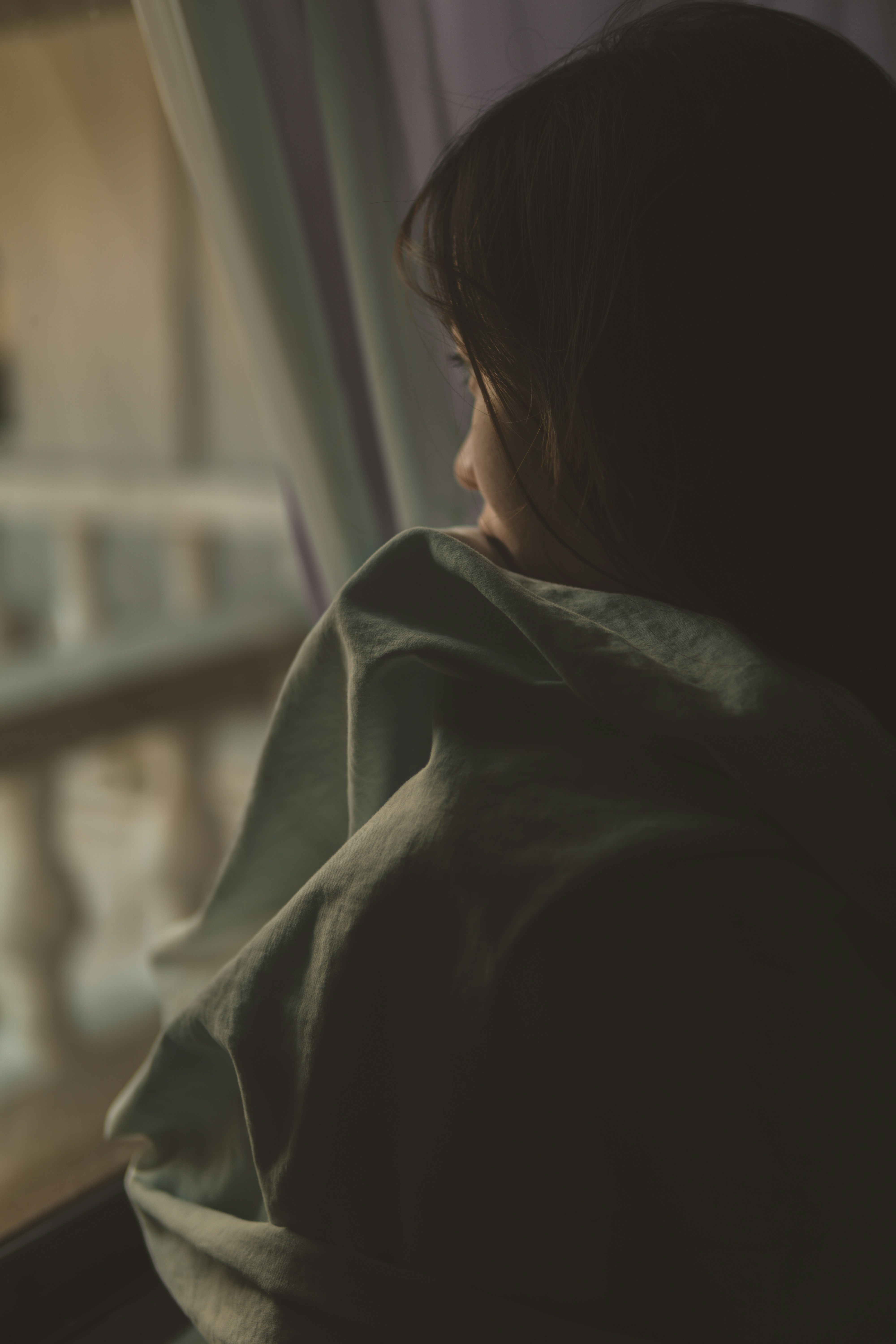 A tired woman looking out the window